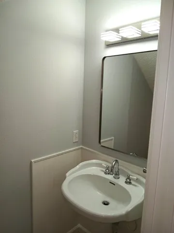 a bathroom with a sink and mirror