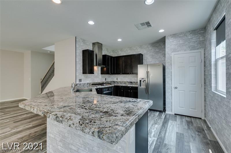 5475 Ordesa Valley Road Las Vegas, NV 89148 - Photo 24 of 35 Granite counters and stainless steel appliances complete this contemporary kitchen, offering modern living.