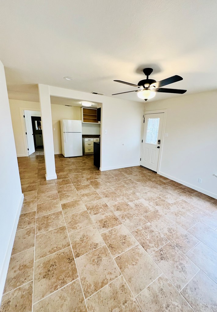 303 Meadow View Lane Kerrville, TX 78028 - Photo 3 of 12 an empty room with white walls and chandelier fan