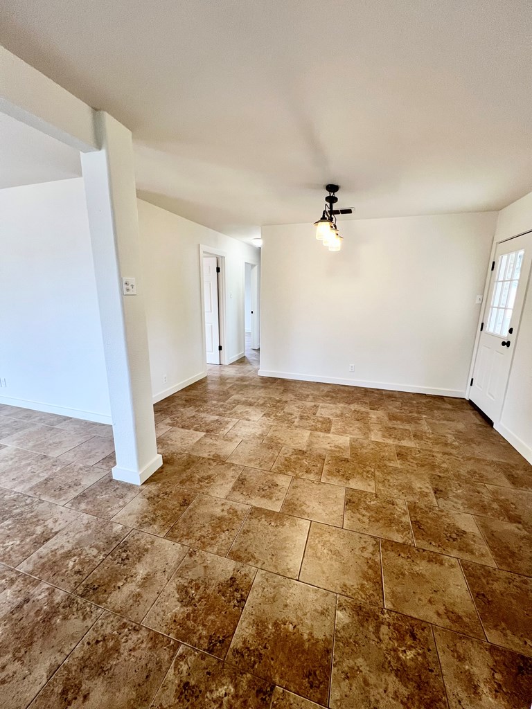 303 Meadow View Lane Kerrville, TX 78028 - Photo 6 of 12 an empty room with a ceiling fan and window
