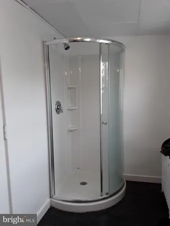 a bathroom with a glass shower door