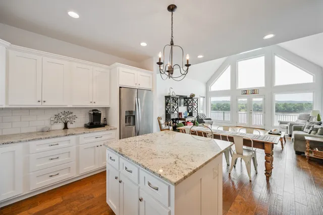 a kitchen with center island and windows