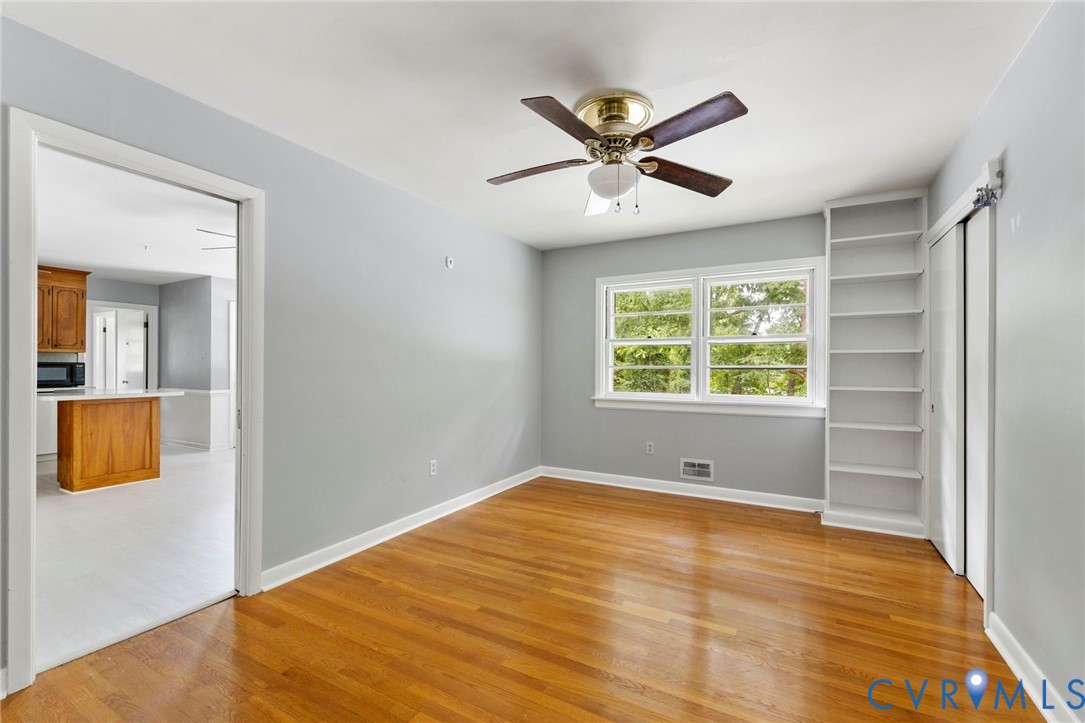 11709 Boyd Road Chester, VA 23831 - Photo 14 of 32 a view of a big room with wooden floor and windows