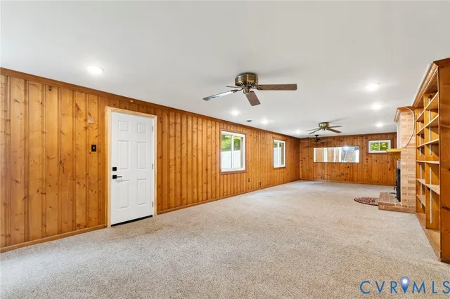 a view of an empty room with a fireplace and a window
