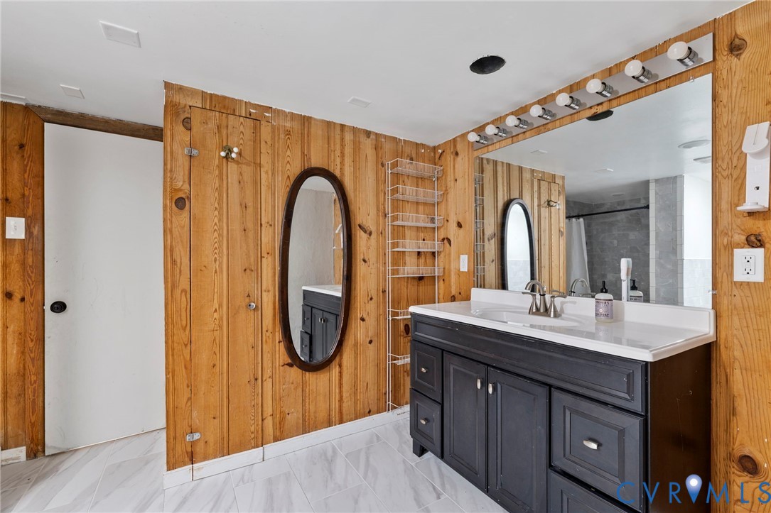 11709 Boyd Road Chester, VA 23831 - Photo 26 of 32 a bathroom with a double vanity sink a mirror and a shower