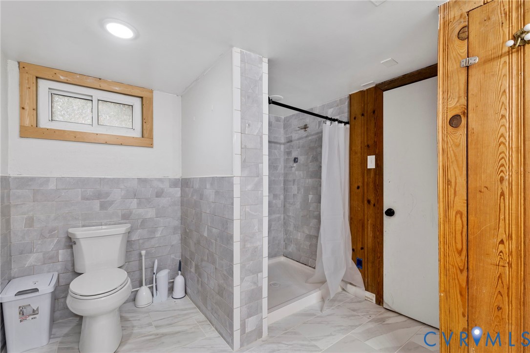11709 Boyd Road Chester, VA 23831 - Photo 27 of 32 a bathroom with a toilet and a shower