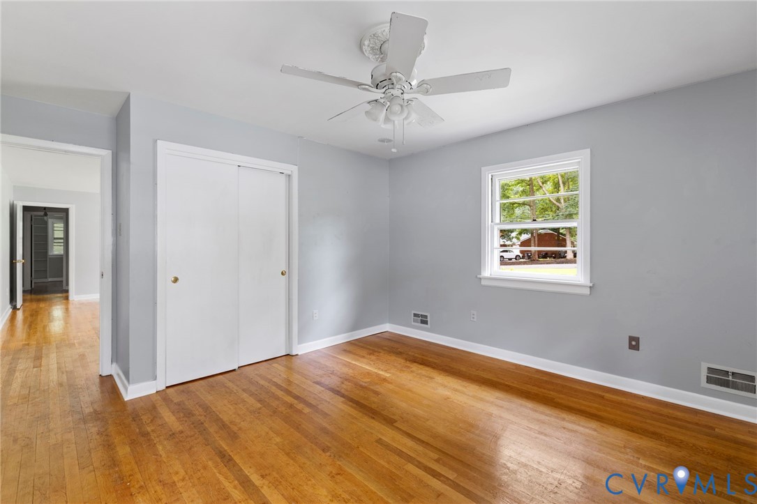 11709 Boyd Road Chester, VA 23831 - Photo 6 of 32 a view of a room with wooden floor and a ceiling fan