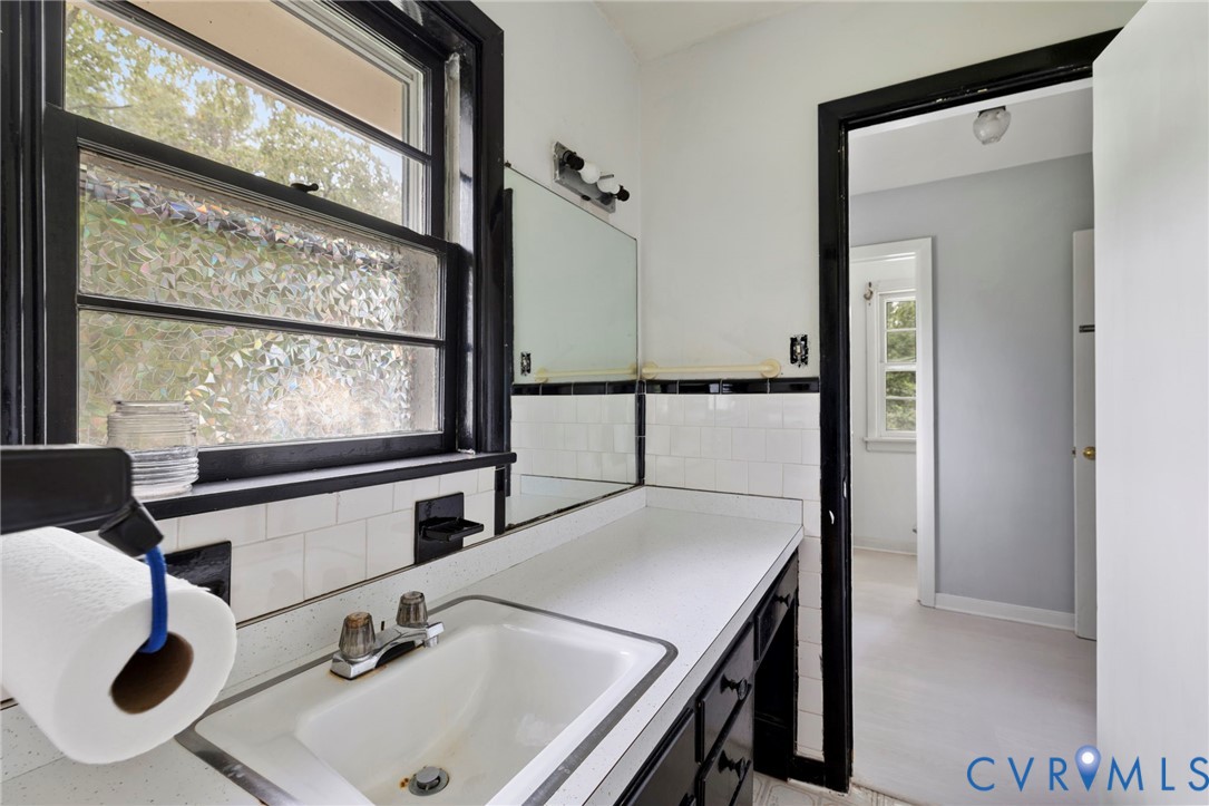 11709 Boyd Road Chester, VA 23831 - Photo 7 of 32 a bathroom with a sink and a mirror