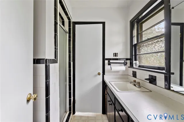 a bathroom with a sink and a large mirror
