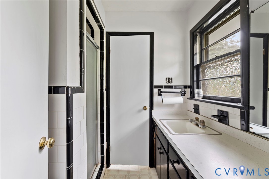 11709 Boyd Road Chester, VA 23831 - Photo 8 of 32 a bathroom with a sink and a large mirror