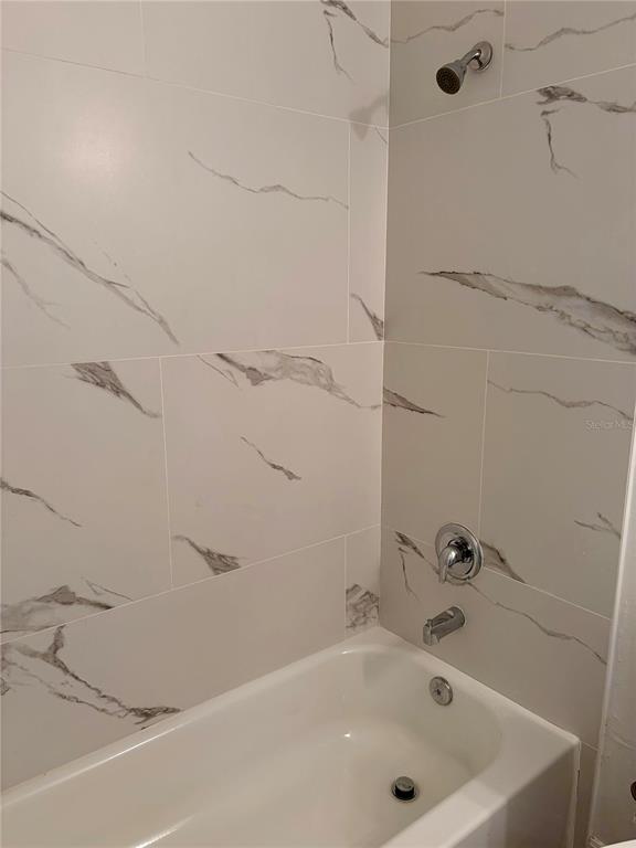 14142 Appleton Boulevard Port Charlotte, FL 33981 - Photo 19 of 26 a bathroom with a tub