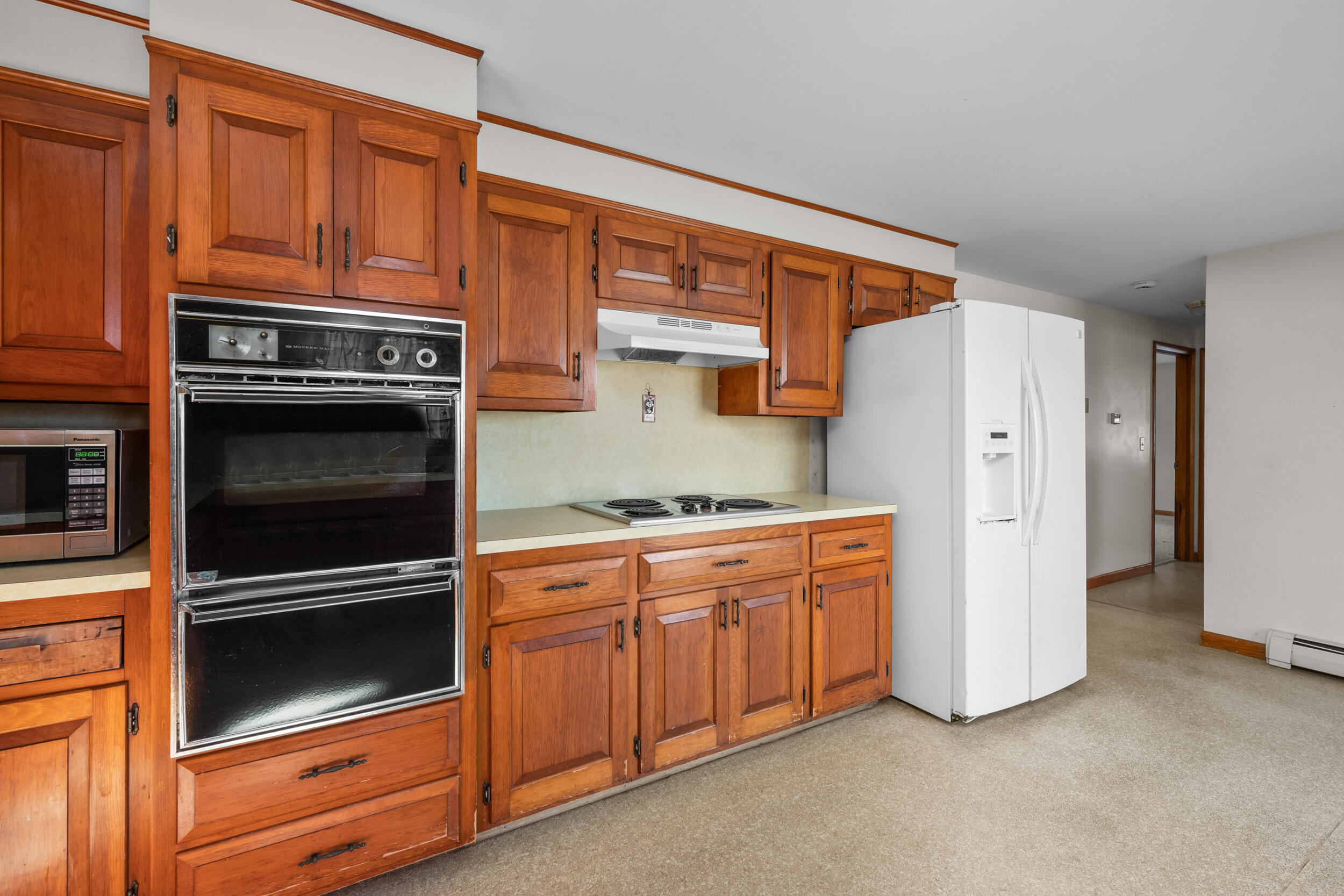 5 Tonset Road Orleans, MA 02653 - Photo 13 of 33 a kitchen with stainless steel appliances granite countertop a refrigerator stove and cabinets