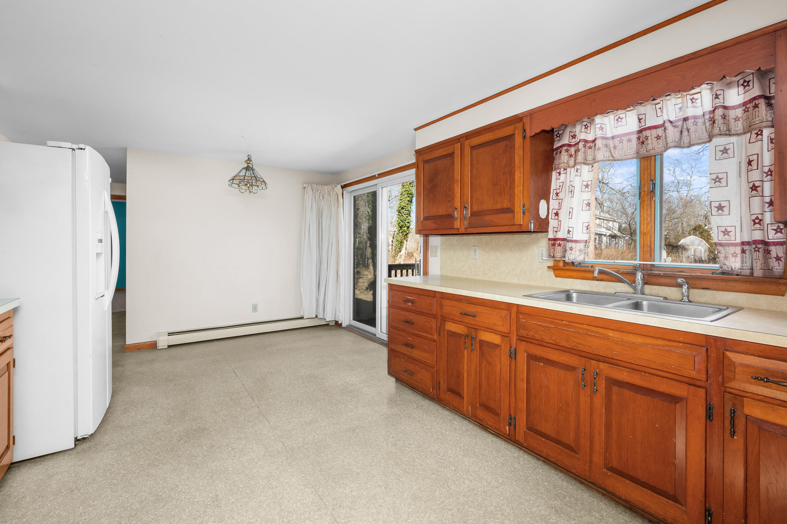 5 Tonset Road Orleans, MA 02653 - Photo 14 of 33 a kitchen with granite countertop a sink and a refrigerator