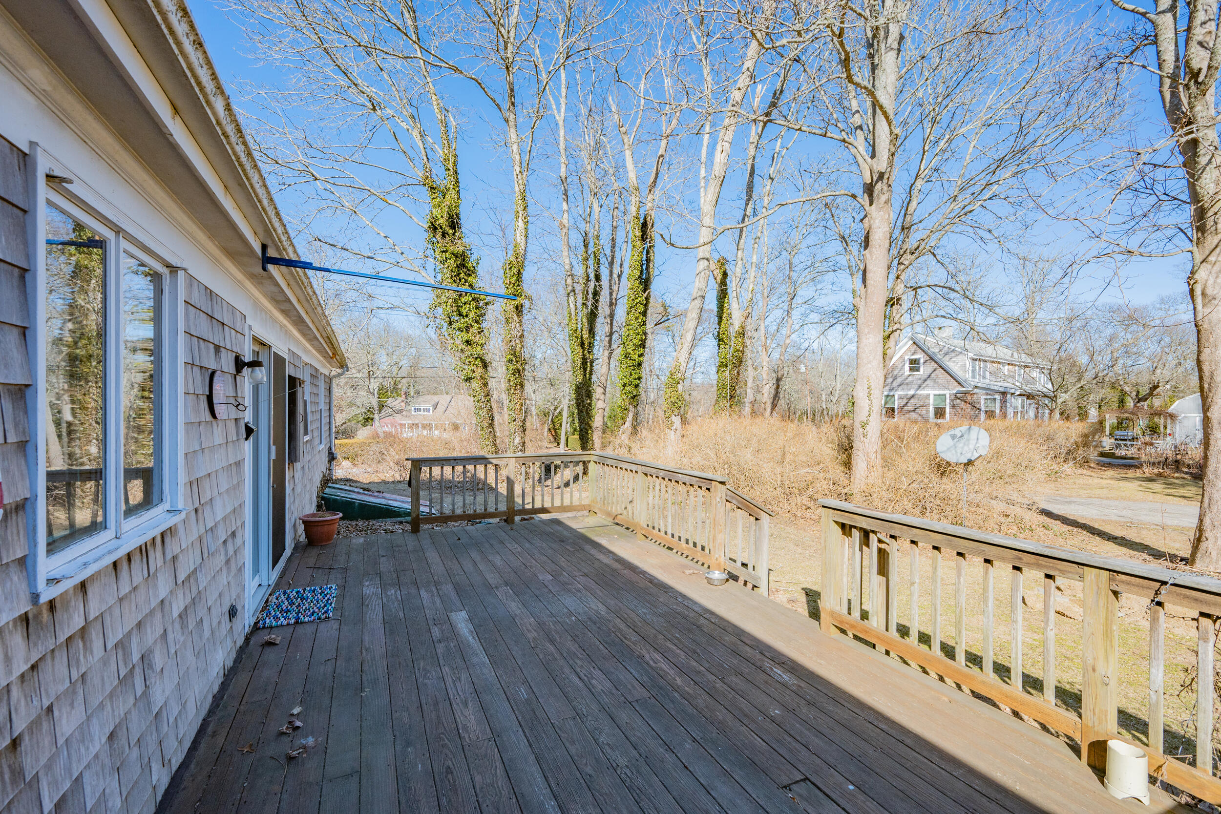 5 Tonset Road Orleans, MA 02653 - Photo 31 of 33 a view of a porch with wooden floor and fence