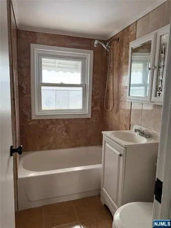 a bathroom with a sink toilet and bathtub