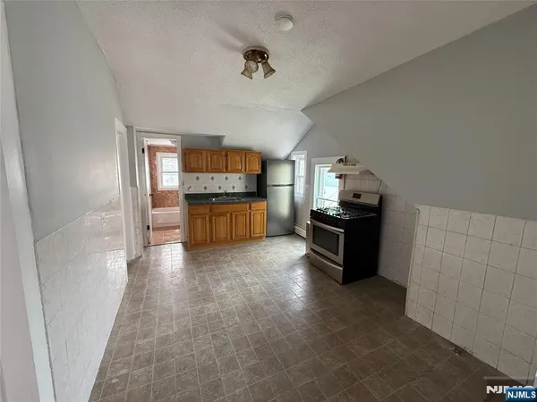 a kitchen with granite countertop a stove and a refrigerator