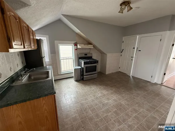 a kitchen that has a sink and a stove