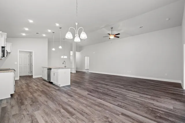 a view of a kitchen with sink and wooden floor