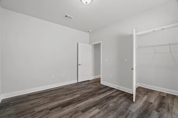 an empty room with wooden floor