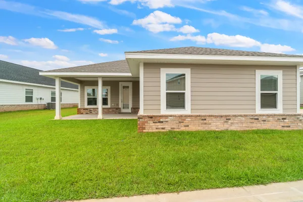 a view of a house with a backyard