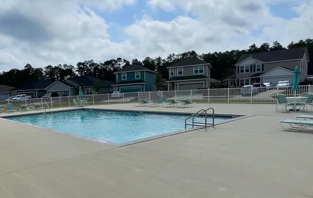 a view of a swimming pool with a lounge chair