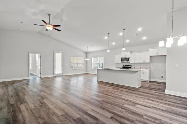 a view of kitchen with cabinets and wooden floor