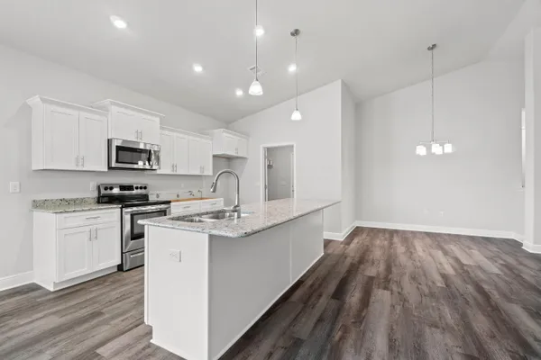 a kitchen with a sink microwave and cabinets