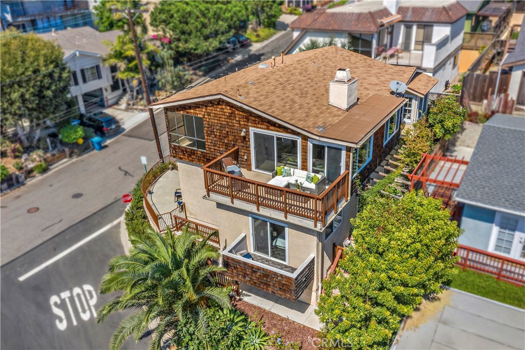 an aerial view of a house with a yard
