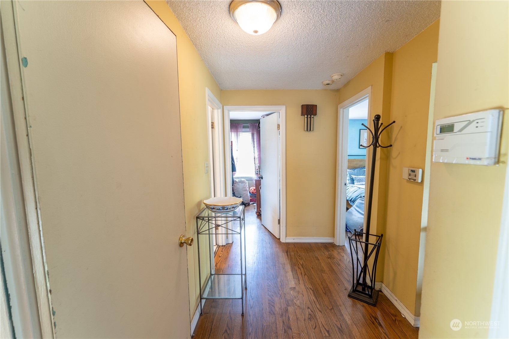 3509 Southwest Trenton Street Seattle, WA 98126 - Photo 12 of 23 a view of a hallway with wooden floor and closet