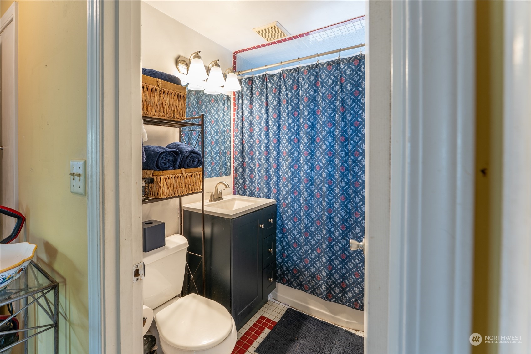 3509 Southwest Trenton Street Seattle, WA 98126 - Photo 16 of 23 a bathroom with a toilet and a shower curtain