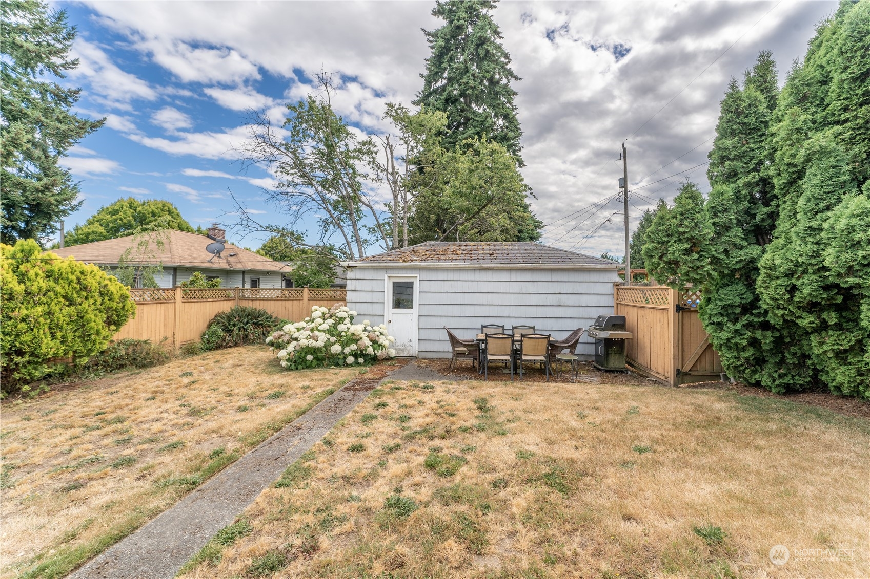 3509 Southwest Trenton Street Seattle, WA 98126 - Photo 20 of 23 a view of backyard with a table and chairs and potted plants