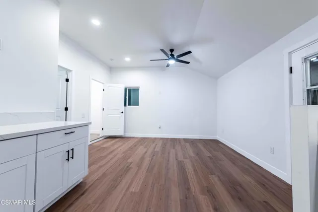 a view of a kitchen with wooden floors and a sink