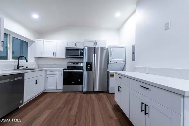 a kitchen with a refrigerator stove and sink