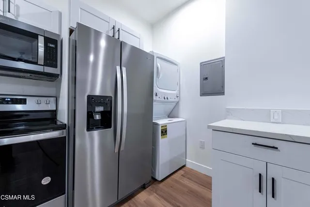 a kitchen with a refrigerator sink and microwave