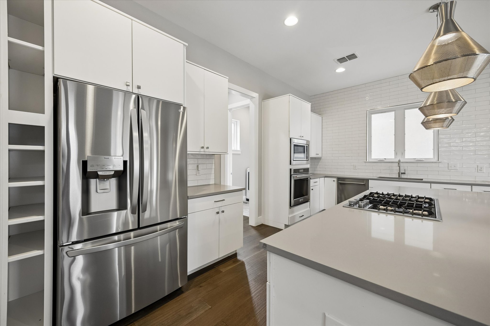 5006 Pecan Springs Road, Unit 6 Austin, TX 78723 - Photo 12 of 30 Culinary delights await in this bright kitchen with modern appliances and sleek countertops.
