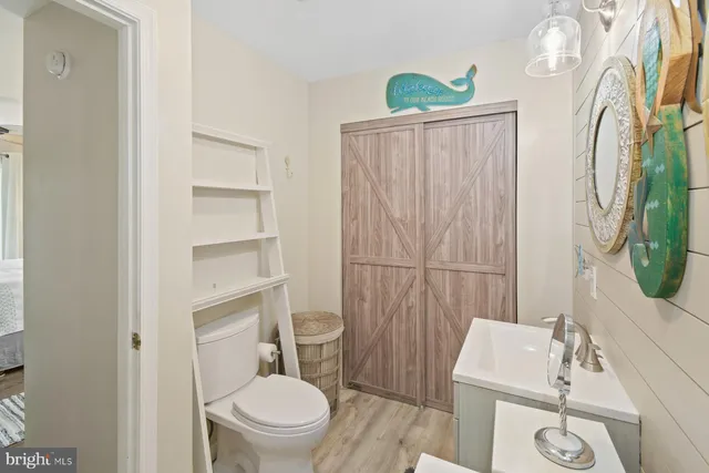 a white toilet sitting next to a bathroom sink