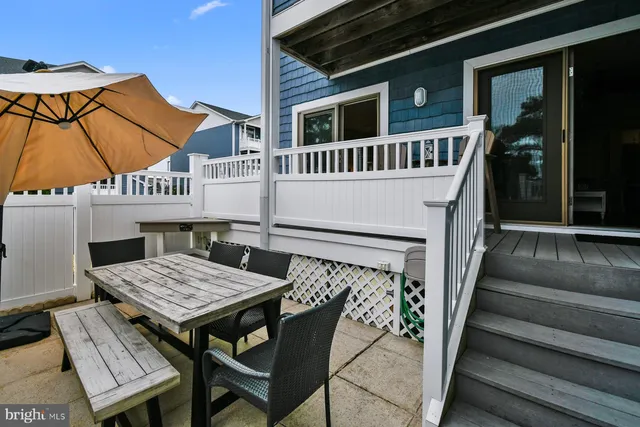 a balcony with table and chairs
