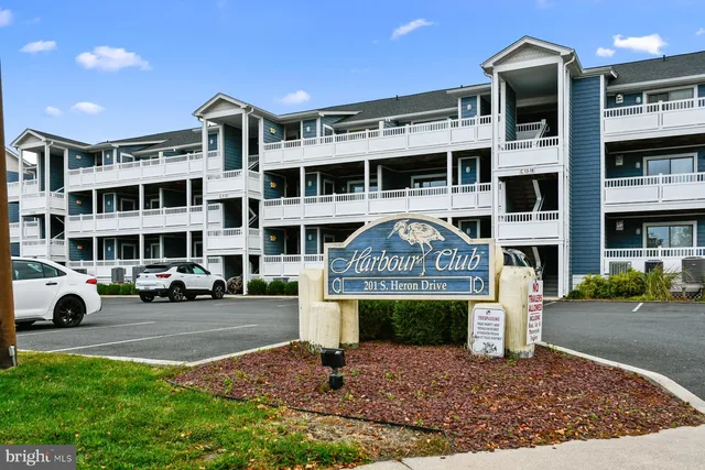 a front view of a building with parking space