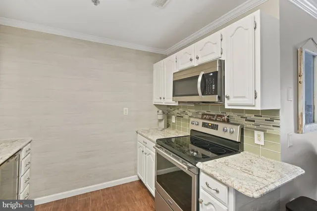 a kitchen with granite countertop a stove top oven and sink
