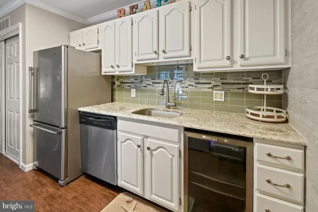 a kitchen with stainless steel appliances granite countertop a refrigerator sink and cabinets