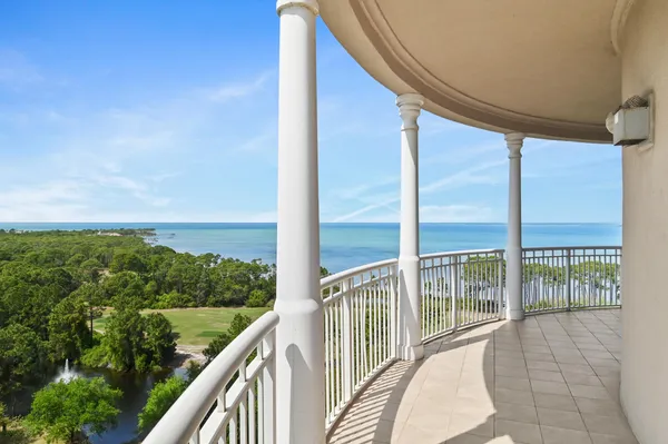 a view of a balcony with couches and sky view