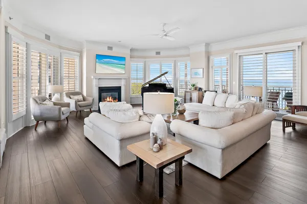 a living room with furniture fireplace and a large window