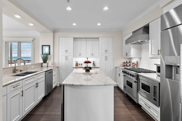 a kitchen with sink stove and refrigerator