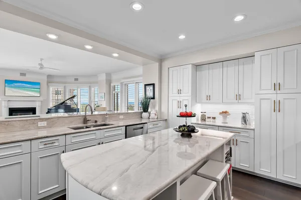 a kitchen with a white cabinets and chairs