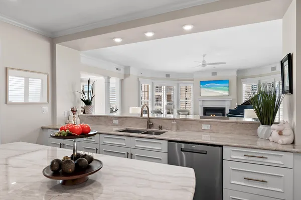 a kitchen with a sink potted plant and cabinets
