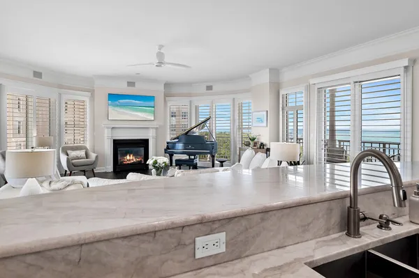 a living room with fireplace furniture and a large window