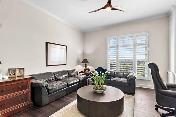 a living room with furniture potted plant and a window