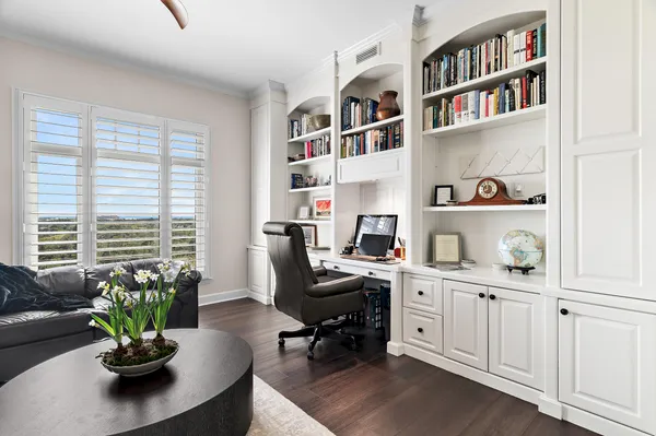 a view of a workspace with a bookshelf