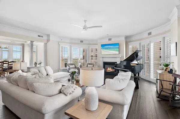 a living room with furniture or wooden floor and a large window