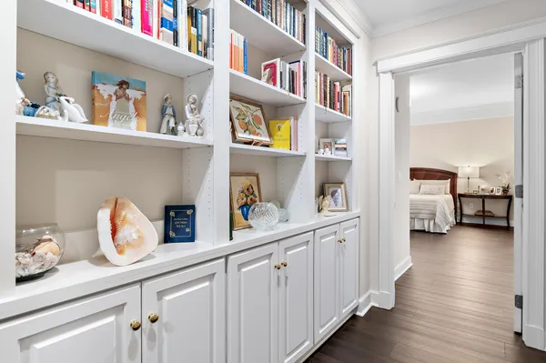 a hallway with cabinets and wooden floor